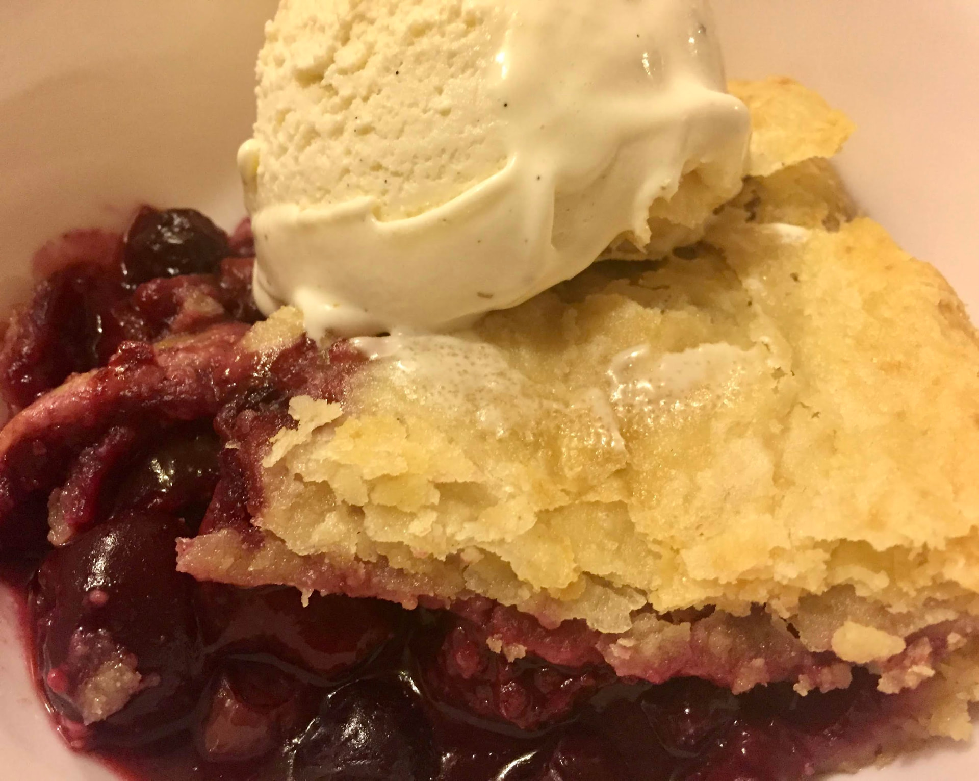 Berry cobbler served with ice cream