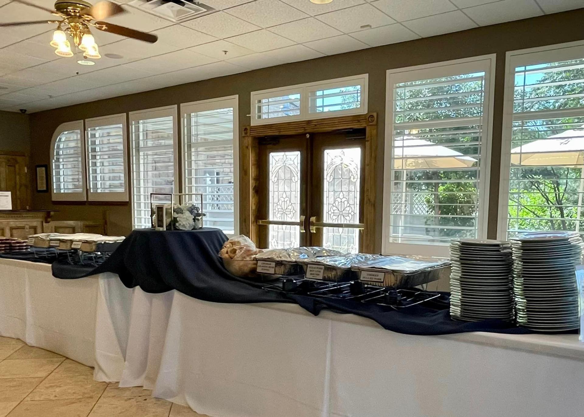 Chafing dishes and plates set up at an elegant manor catering event