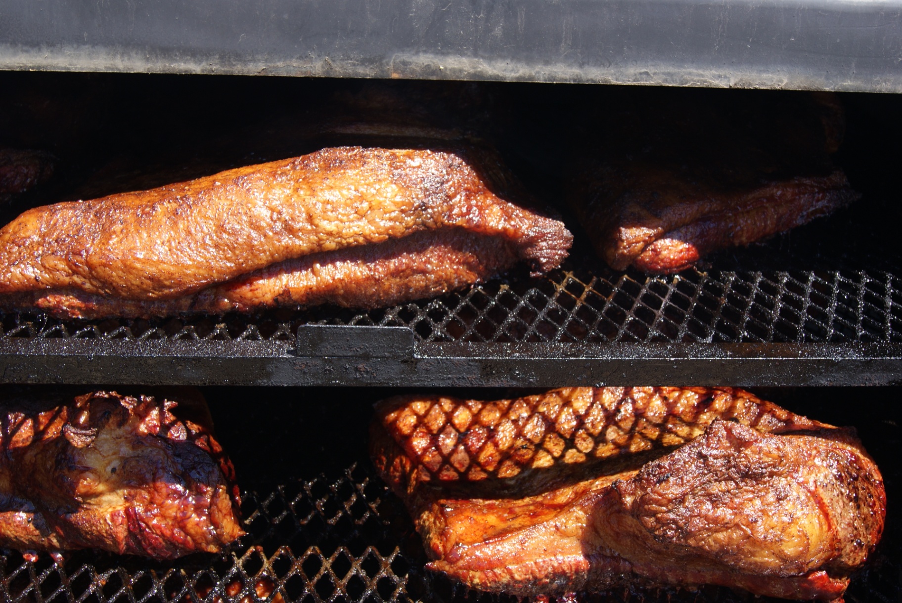 Briskets smoking on the custom 23' offset smoker