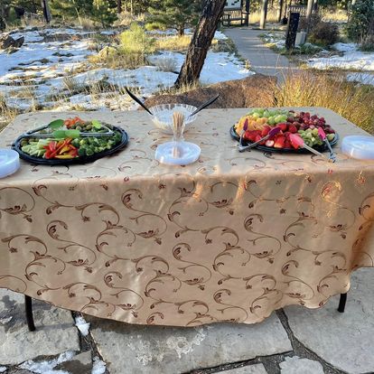 Fresh fruit and veggie trays set up outdoors at a mountain manor wedding