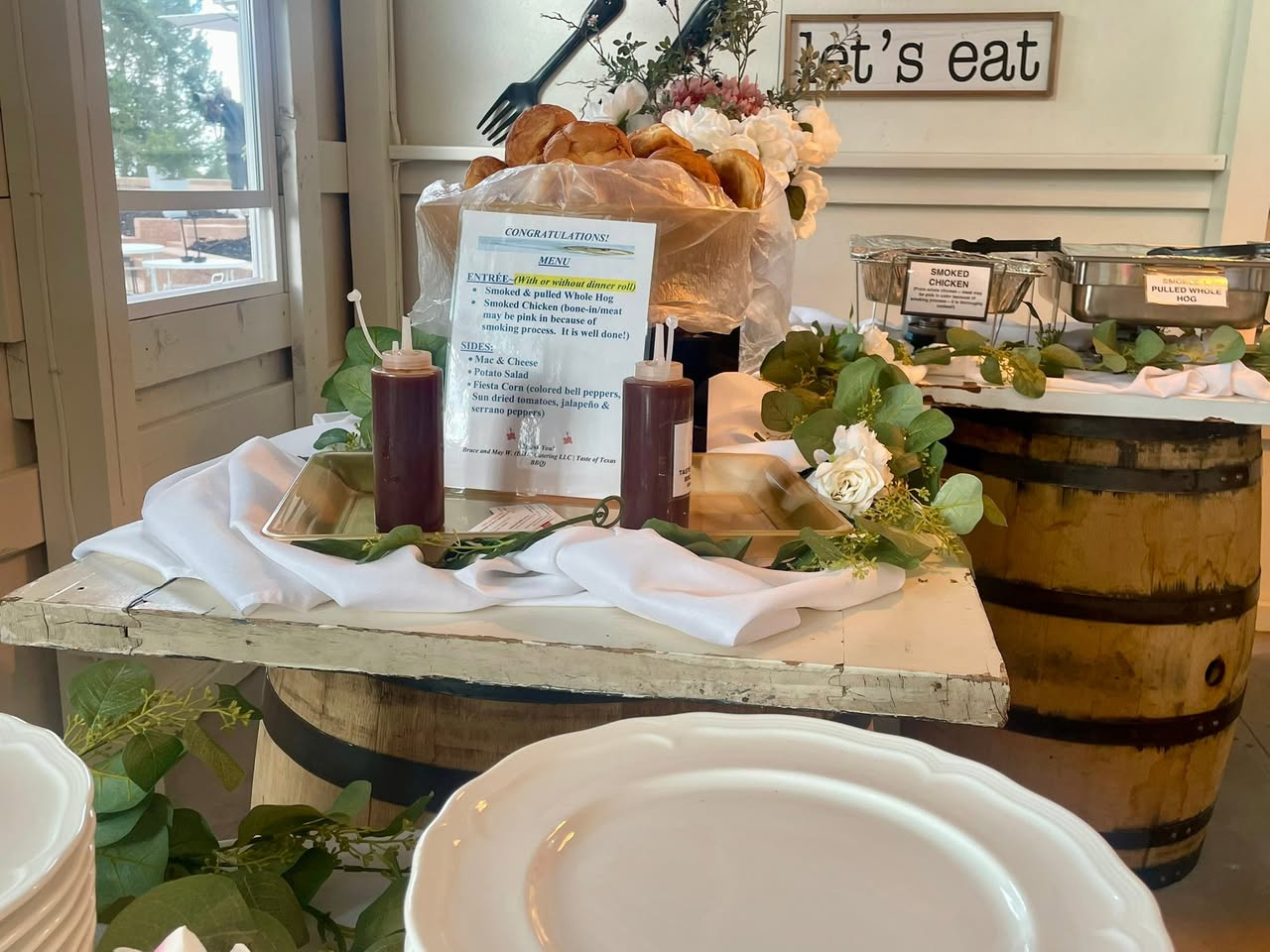 Mountain wedding buffet with whole hog and smoked chicken chafers on wine barrels