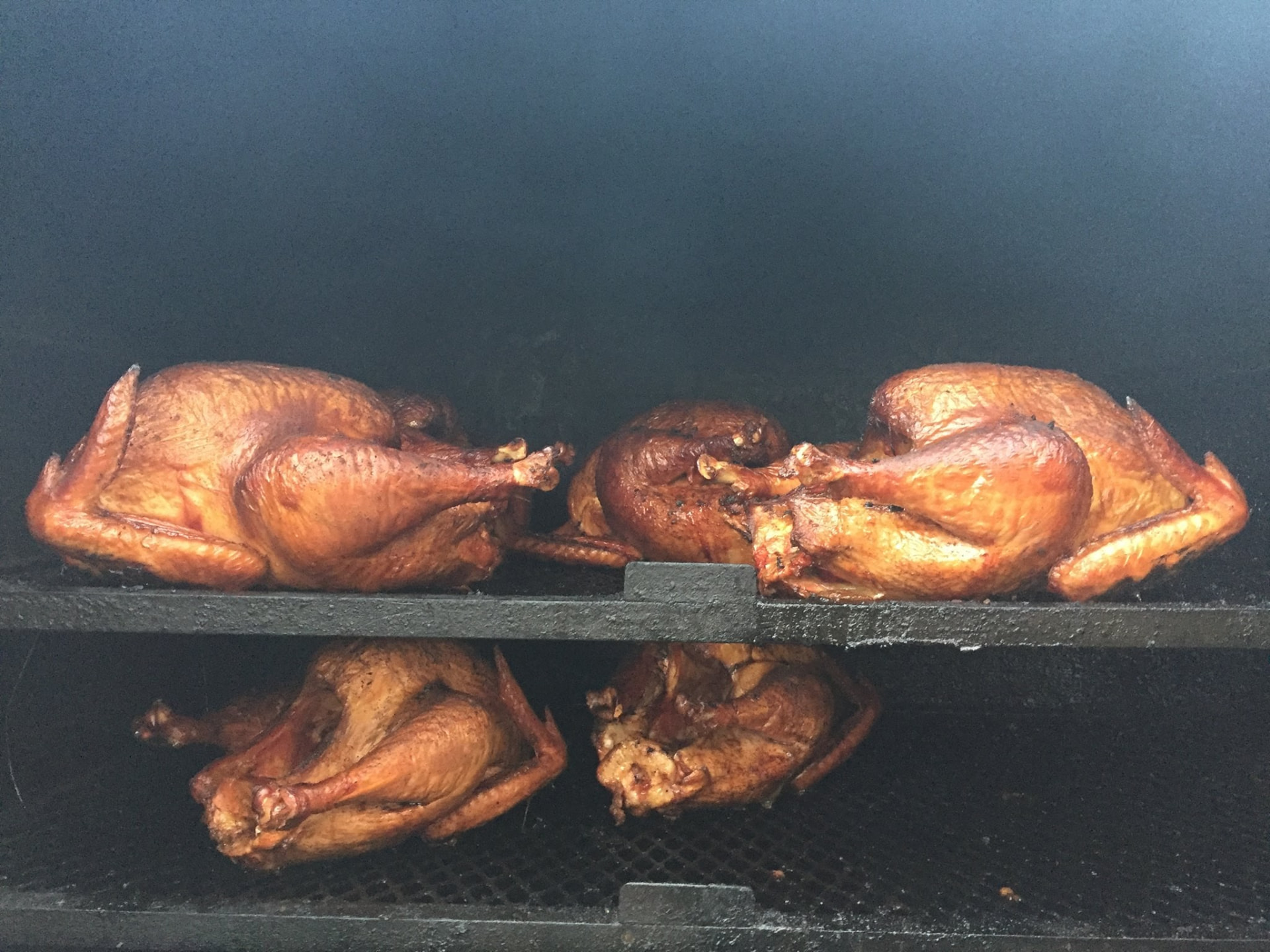 Smoked turkeys cooking low and slow on the smoker