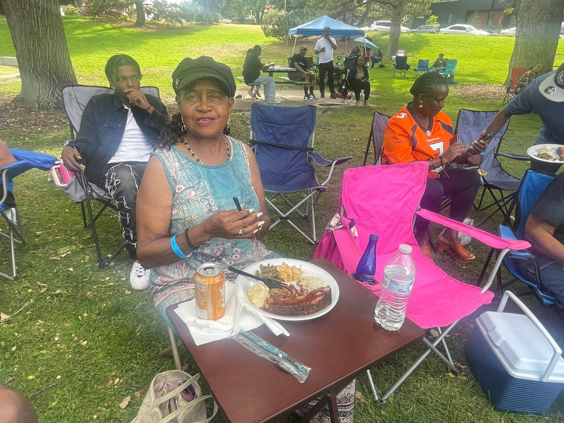 Guest at a family reunion with a plate of ribs, mac & cheese and green beans