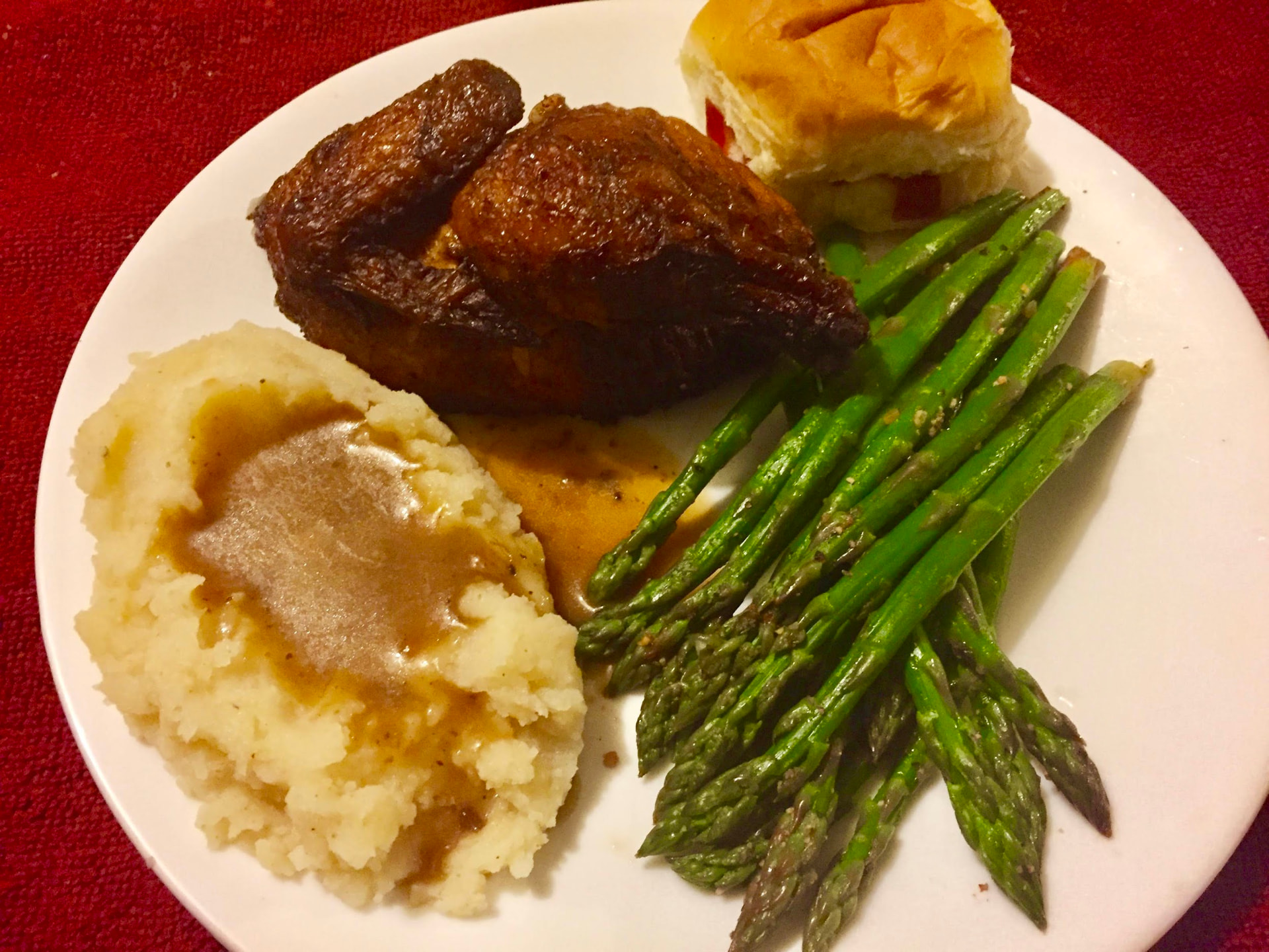 Cornish hen served with steamed asparagus and mashed potatoes